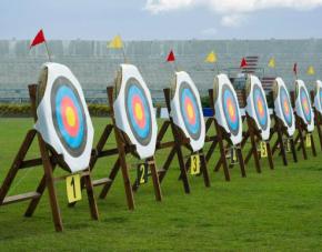 archery targets aligned on grass for outdoor team building activity