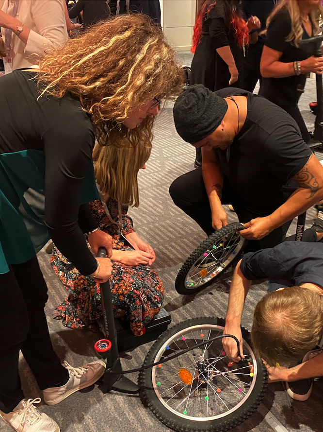 people assembling bikes in charity team building event