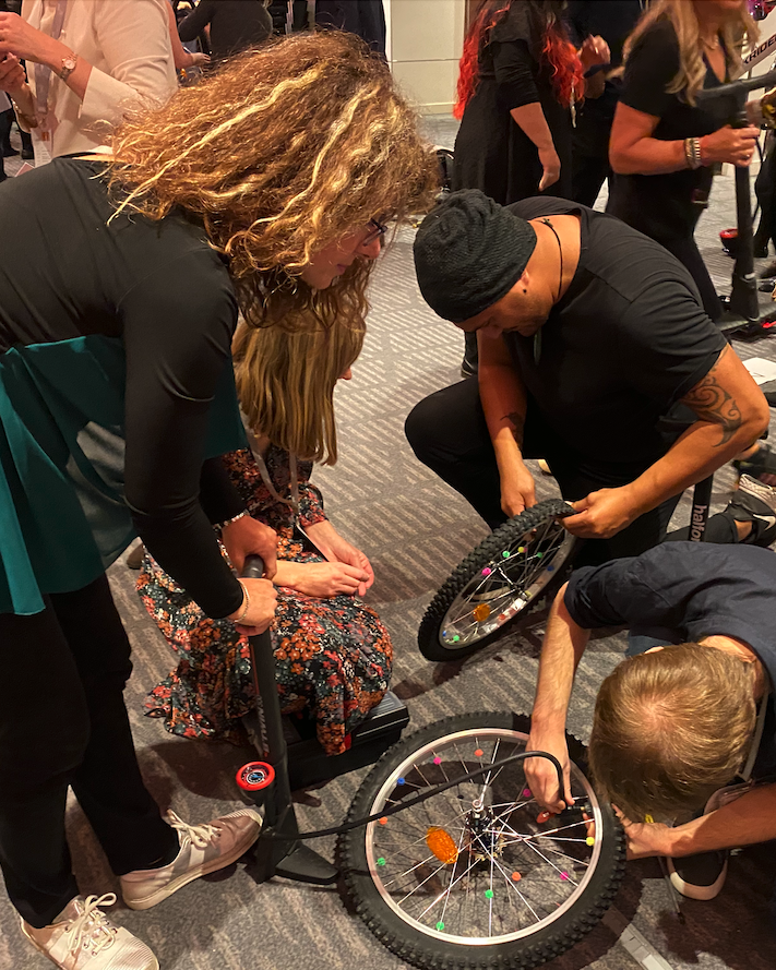 people assembling bikes in charity team building event