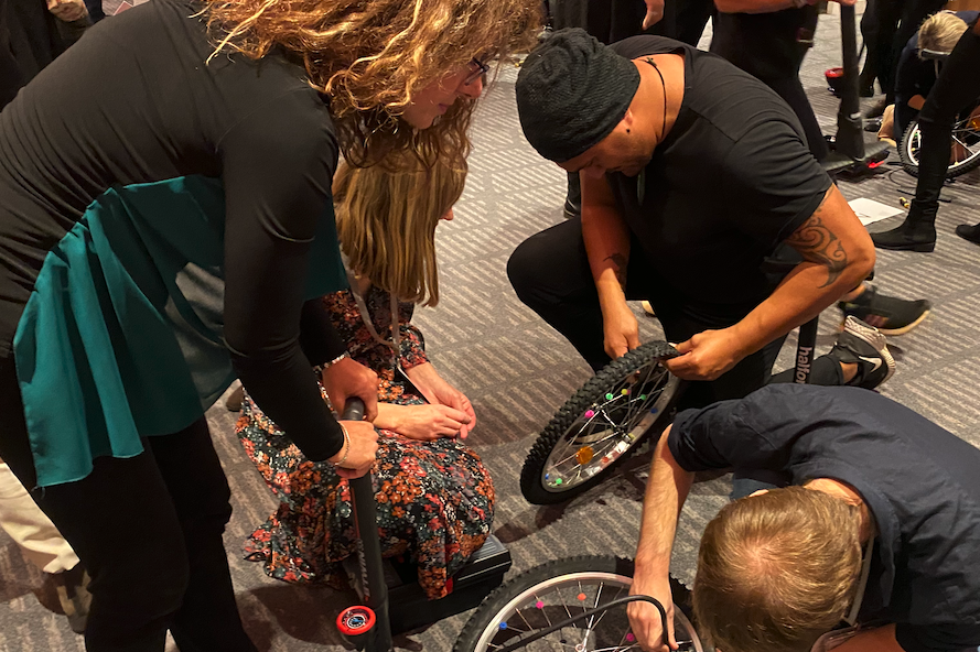 people assembling bikes in charity team building event