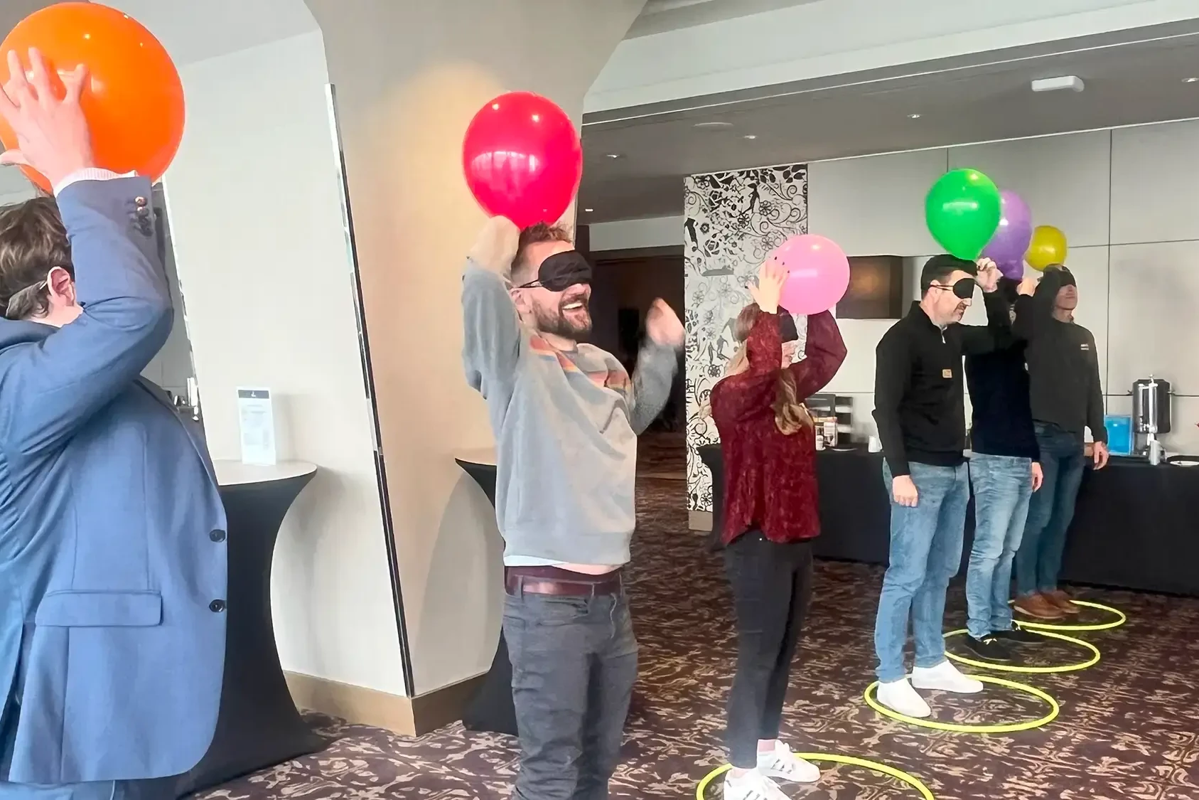 People participating in balloon challenge in charity bike build team building