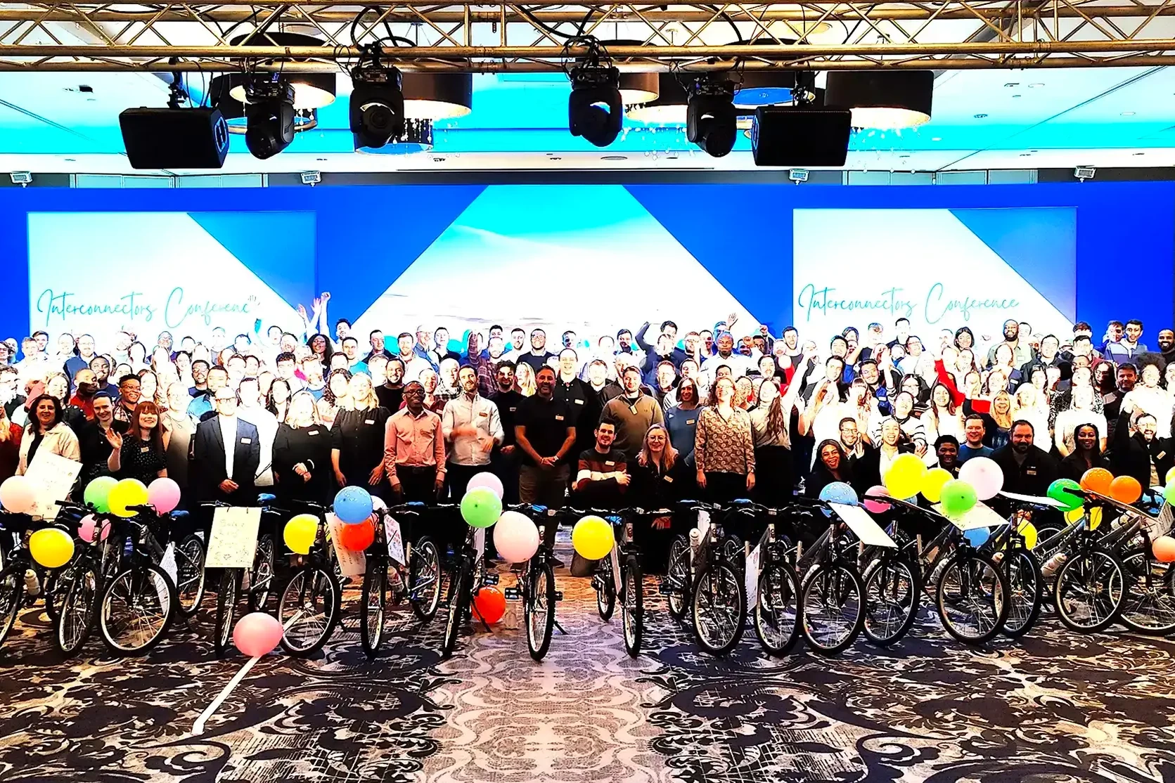 large group of people and bikes in charity bike build