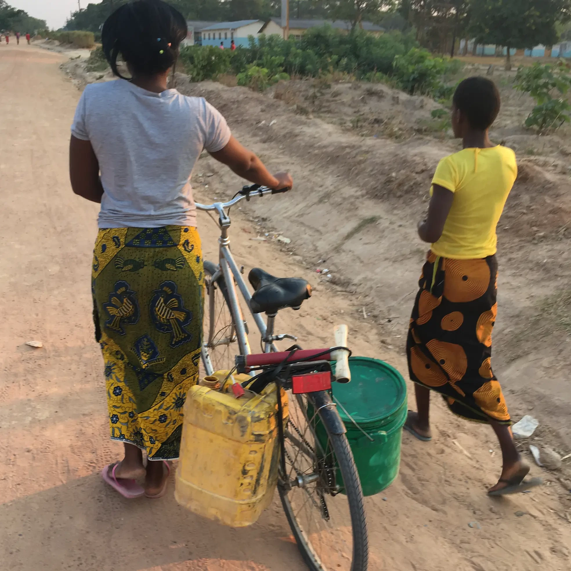 Women in Africa using bike form bike build event to transport water
