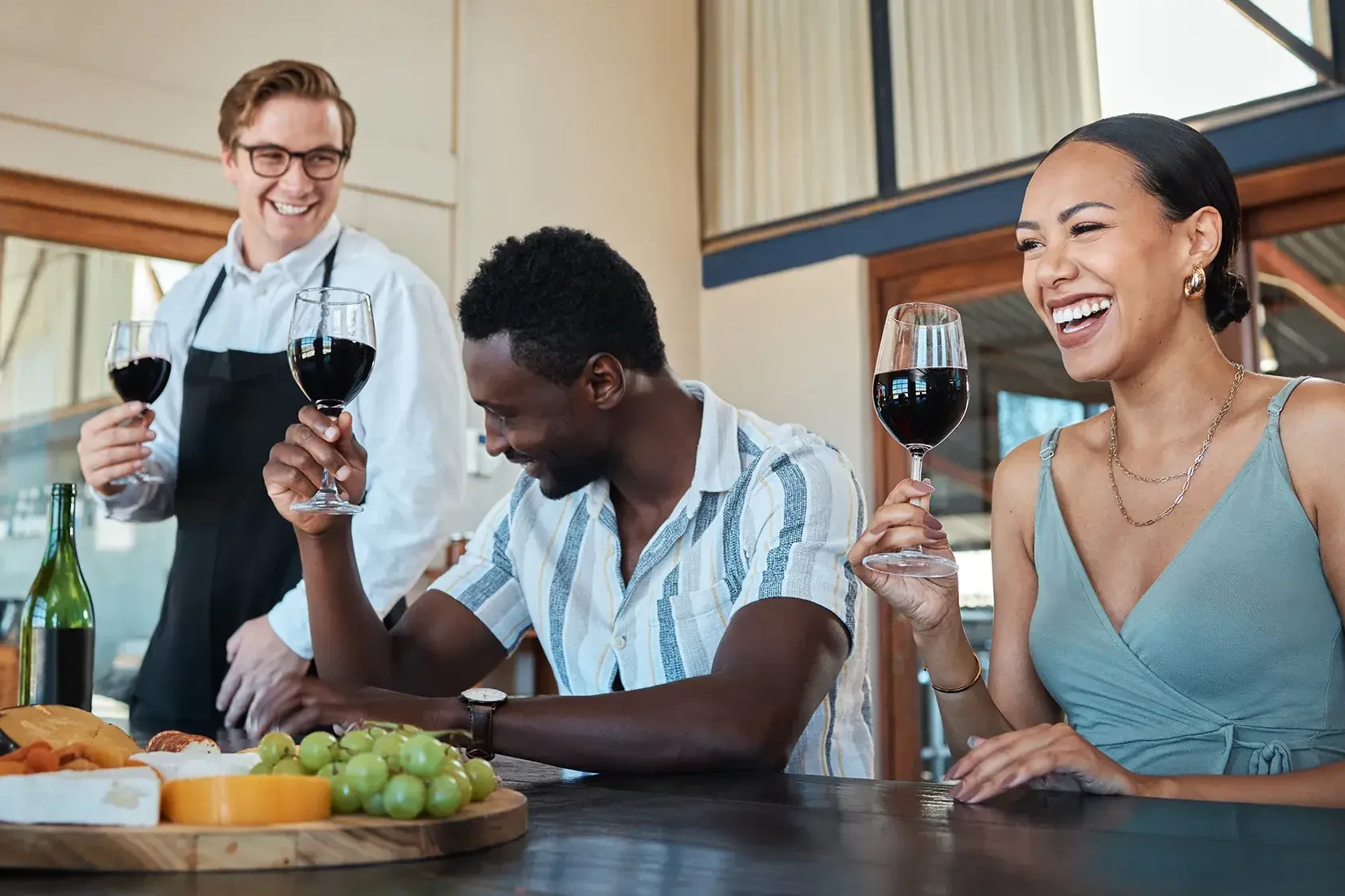 People laughing and having a good time in their team cheese and wine tasting