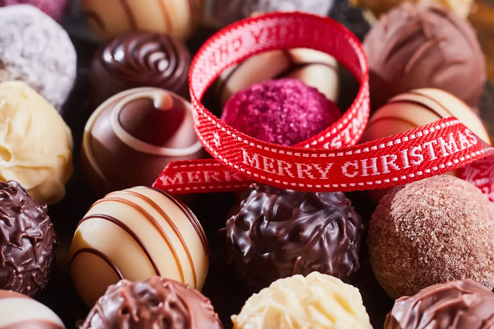 Christmas chocolates and red ribbon