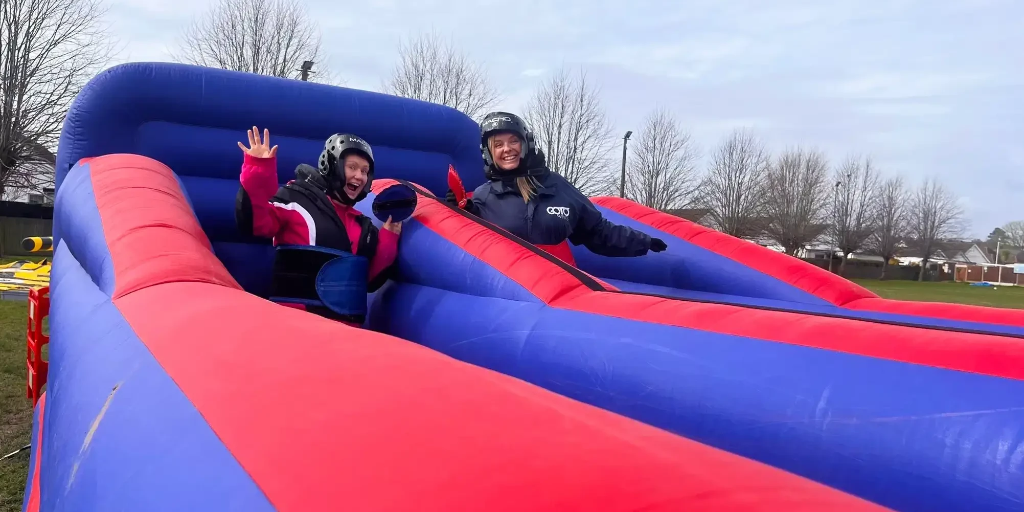 people having fun on slippery slides in outdoor team building event