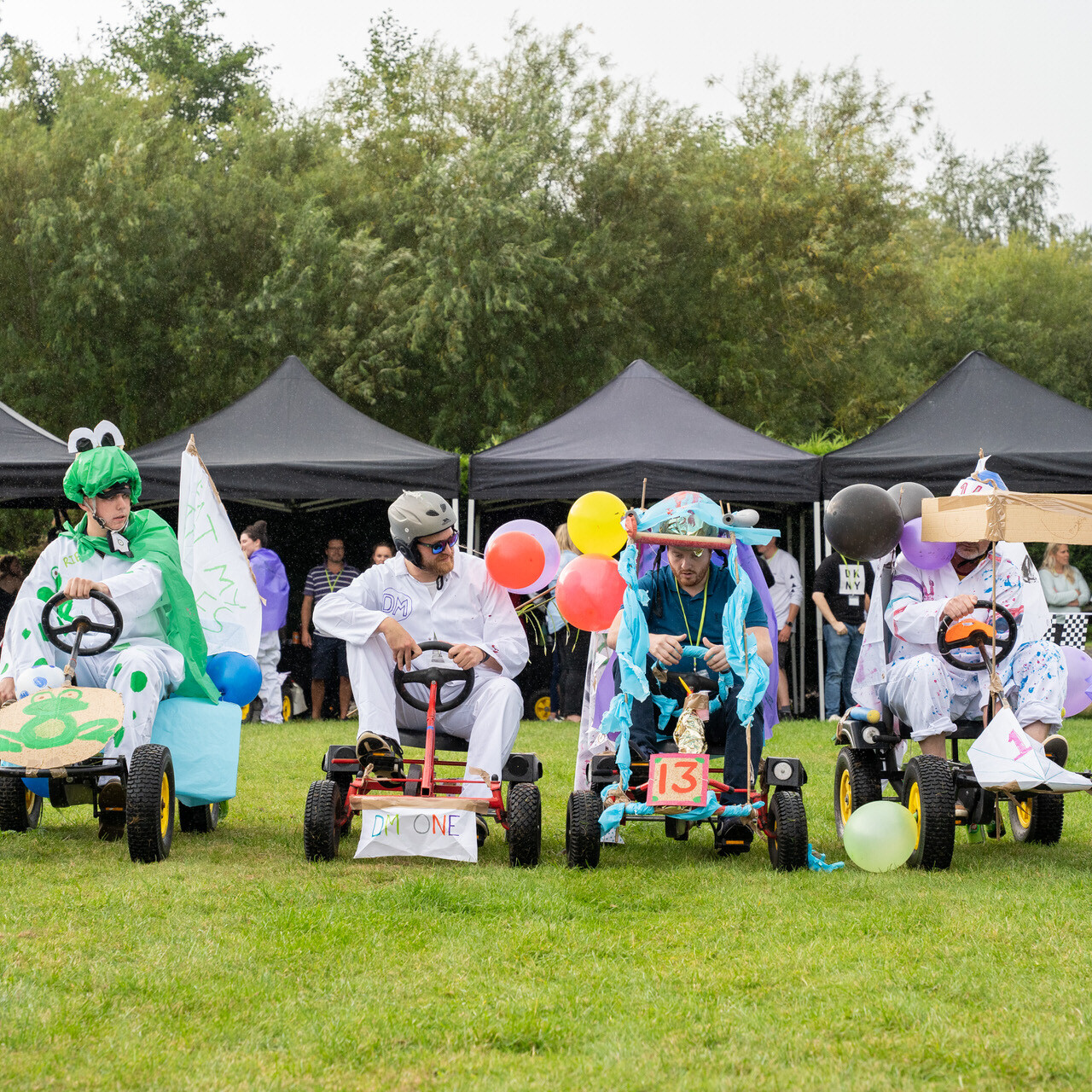 Employees competing in Soap Box Derby race in corporate summer event