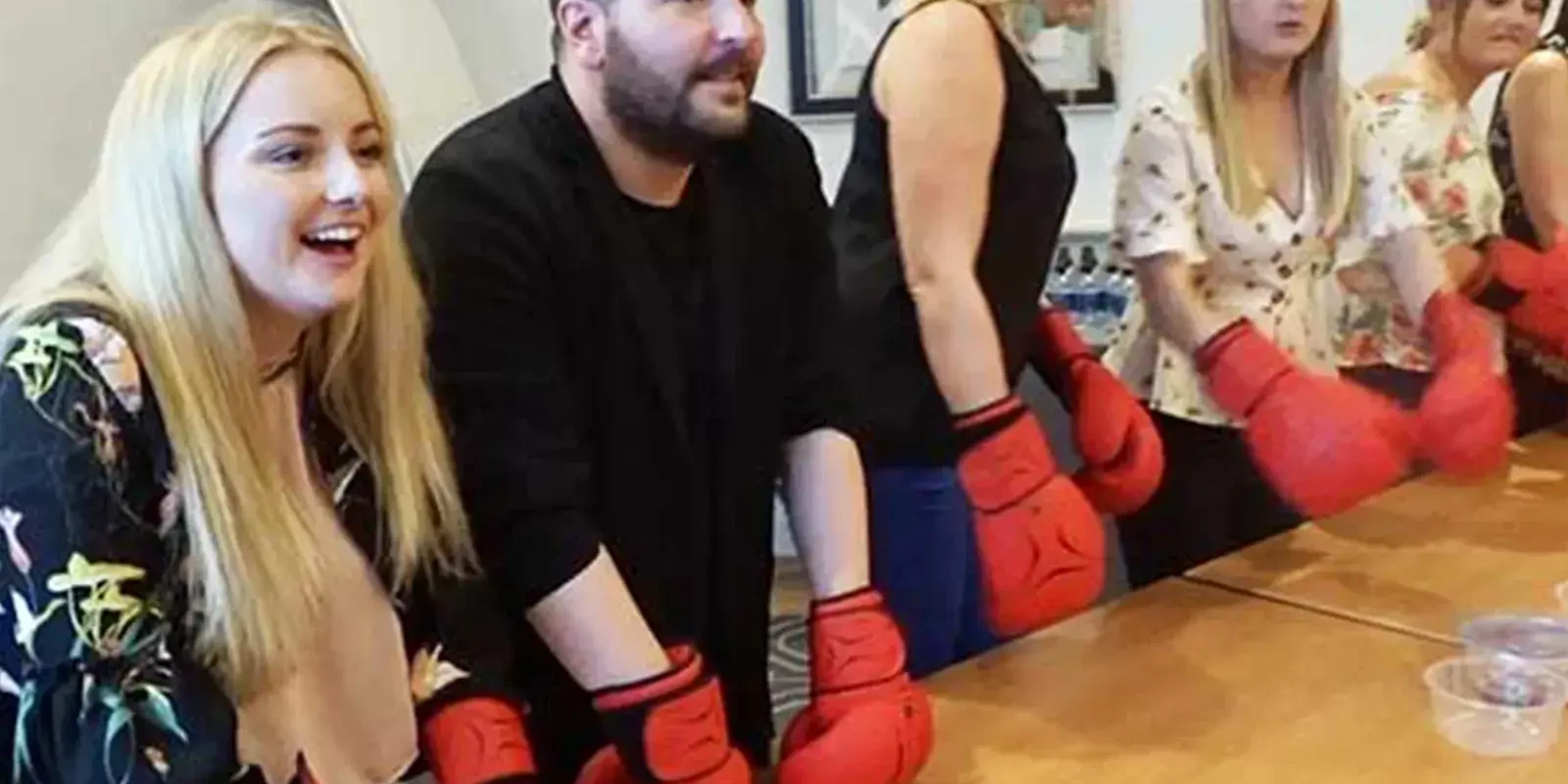 Master of the tasks team building challenge with people wearing boxing gloves