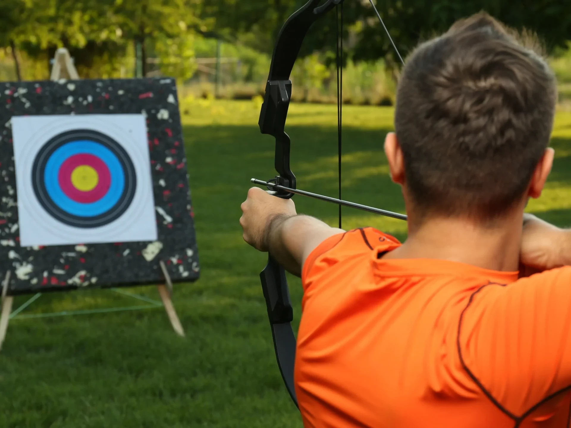 Person aiming at target in archery team building activity