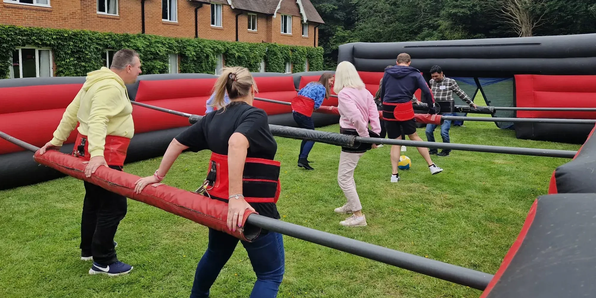 people playing football in Olympic sports day human table football