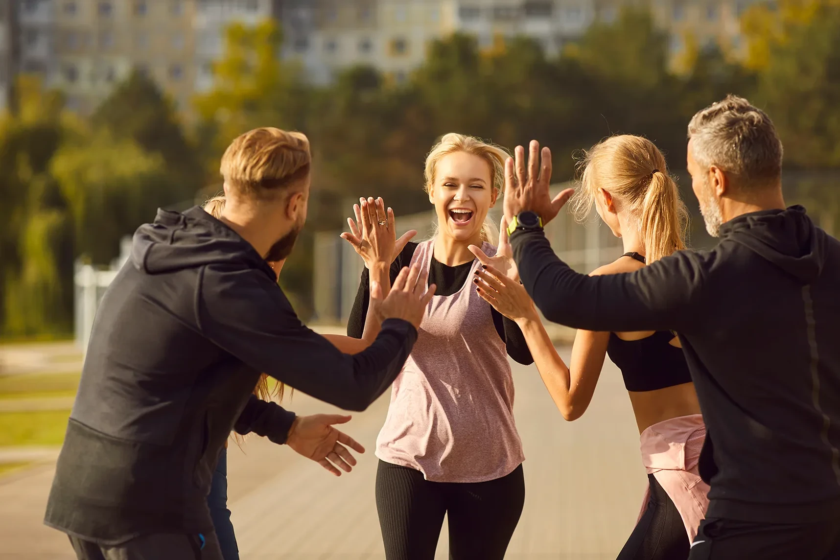 Colleagues participating in a team workout in a city park.