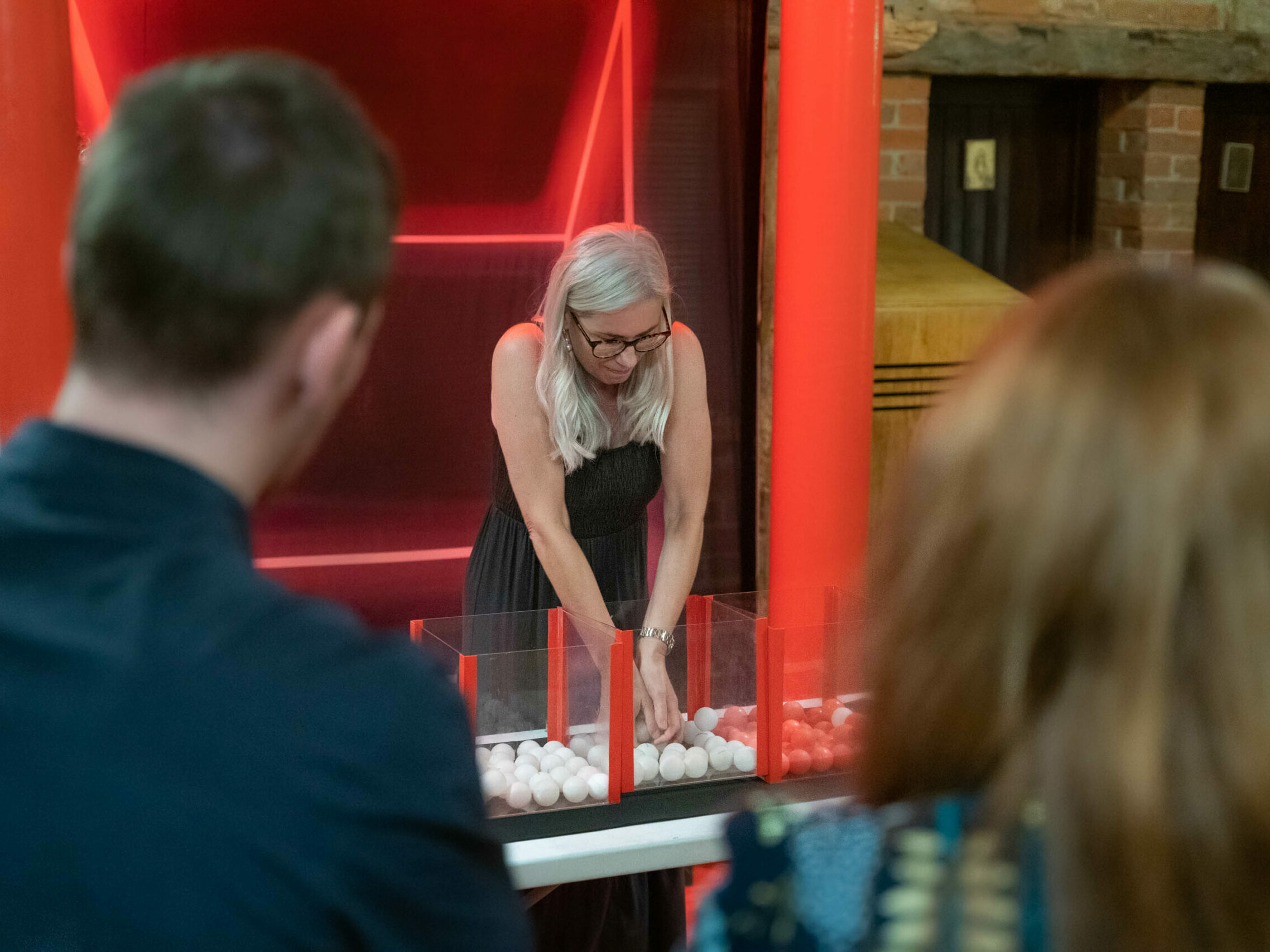 A woman separating coloured balls during an Under Pressure team building game