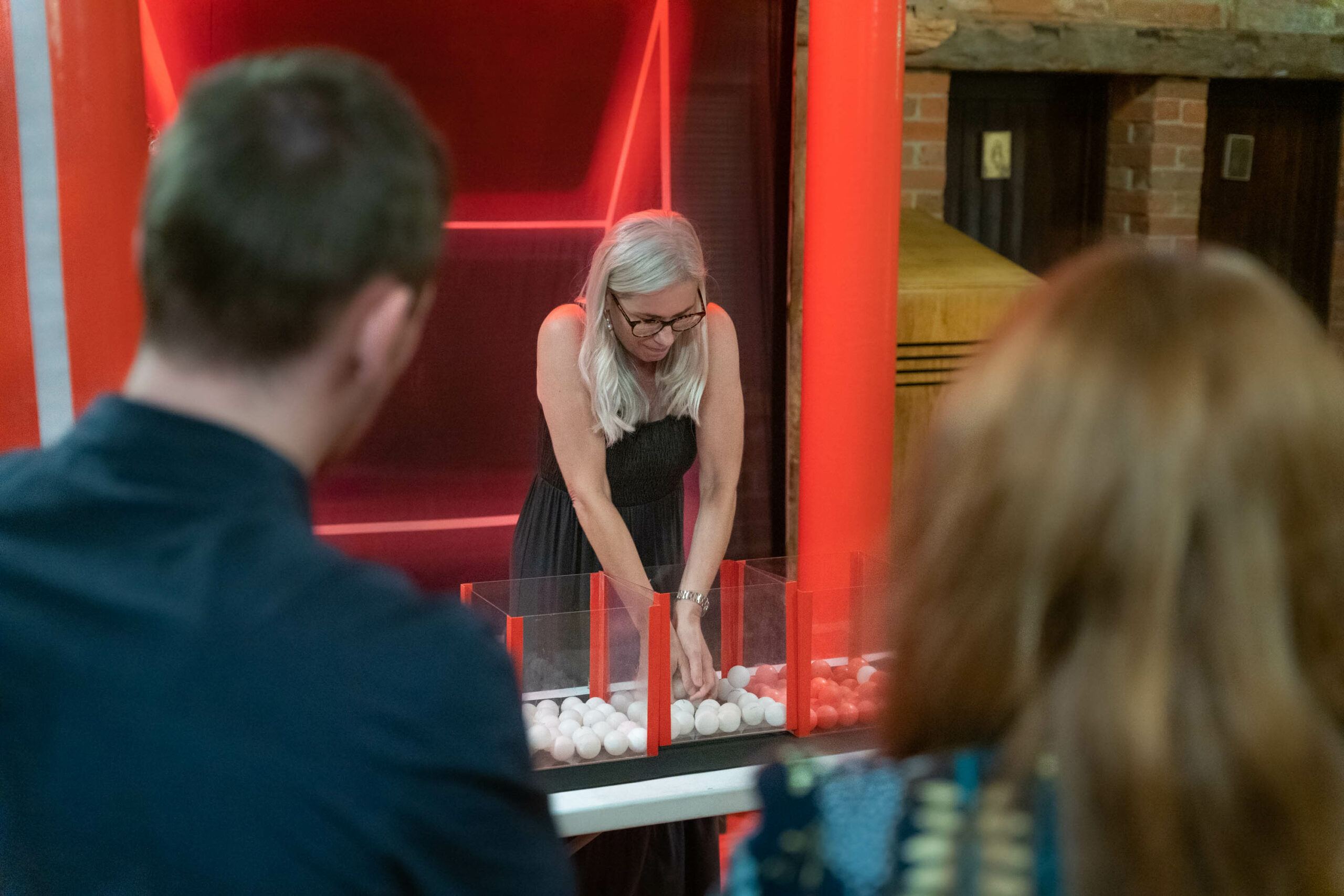 A woman separating coloured balls during an Under Pressure team building game
