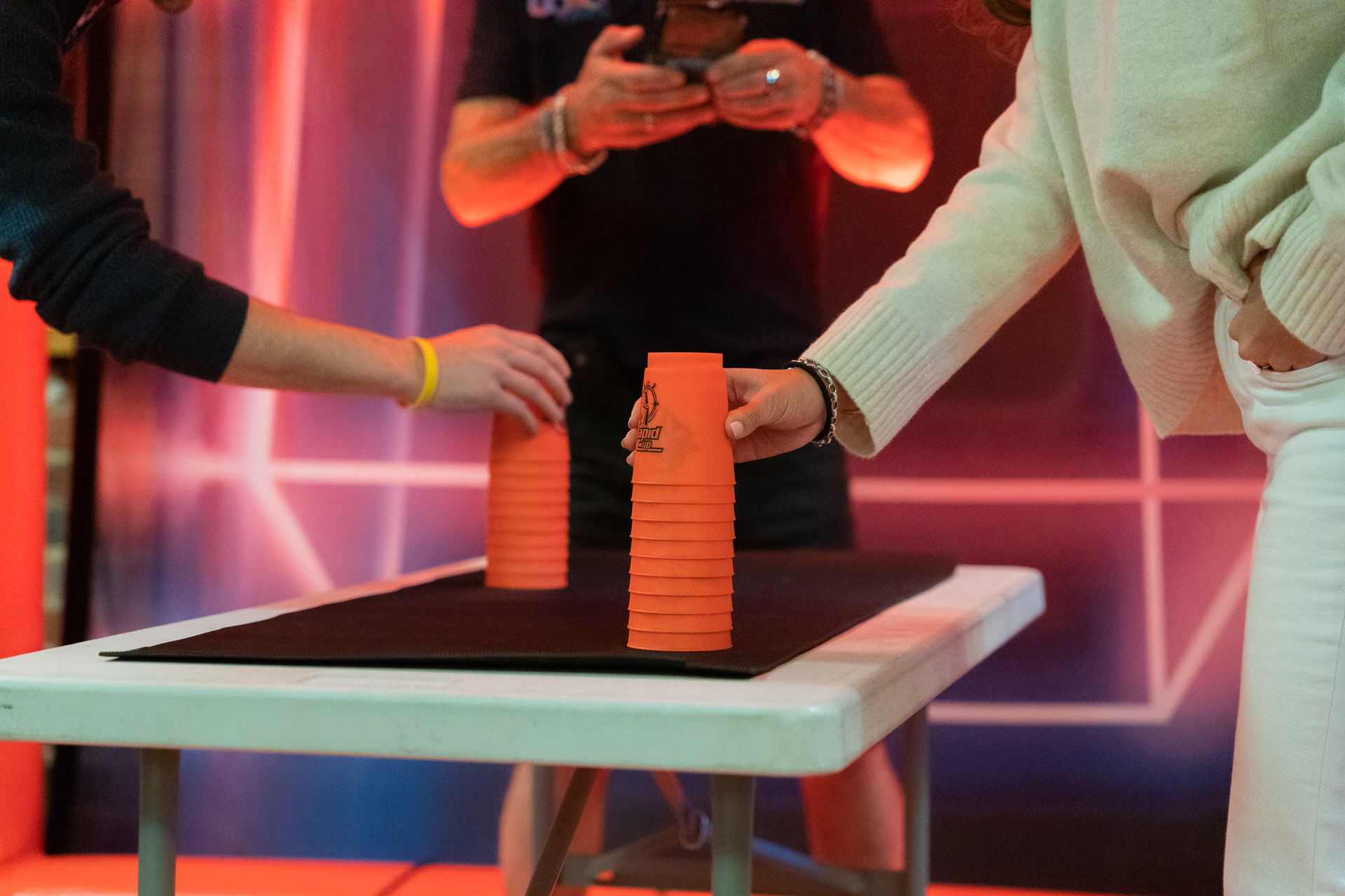A team stacking cups during an Under Pressure team building game