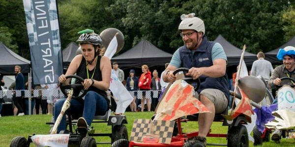 Teams racing pedal powered karts on soap box derby team building events