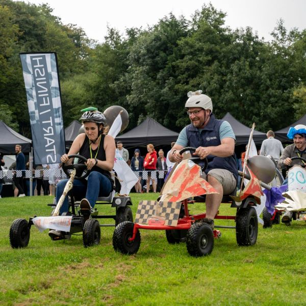 Teams racing pedal powered karts on soap box derby team building events