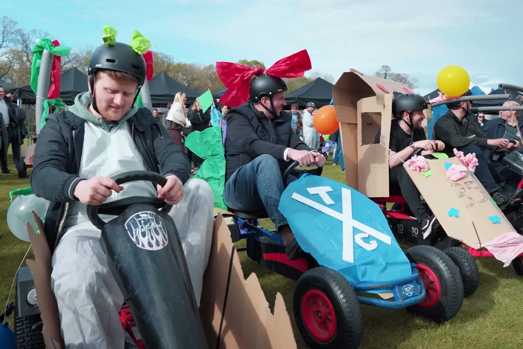 Team participating in Soap Box Derby team building activity with decorated pedal carts
