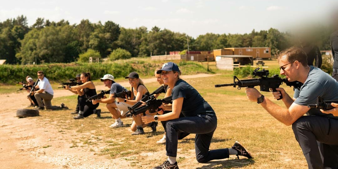 A line up of The Who Dares Experience participants with rifles.