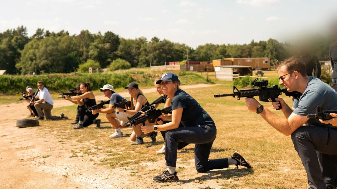 A line up of The Who Dares Experience participants with rifles.