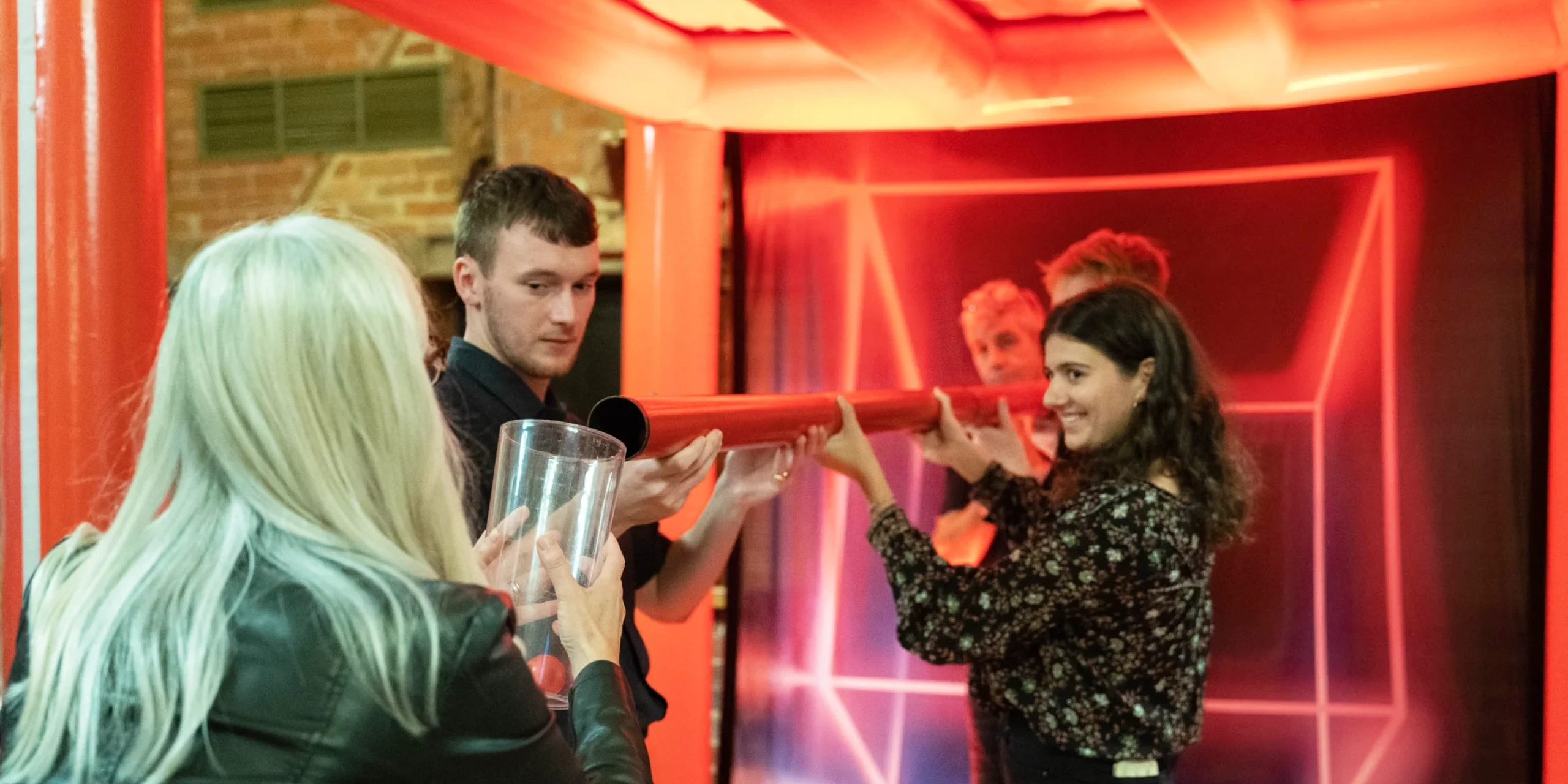 Adults playing a challenge in an indoor team building event