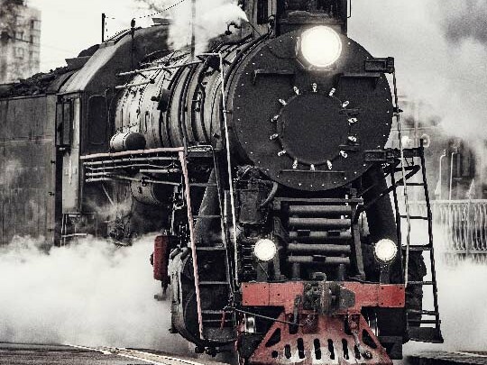Steam train on railroad tracks