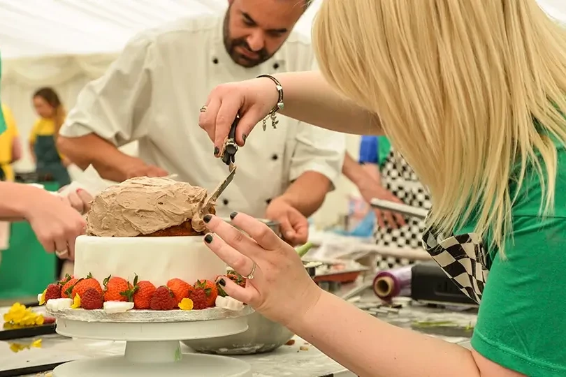 Decorating cake at baking team building activity