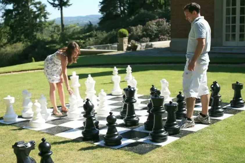 people playing giant chess on grass in beautiful outdoor venue