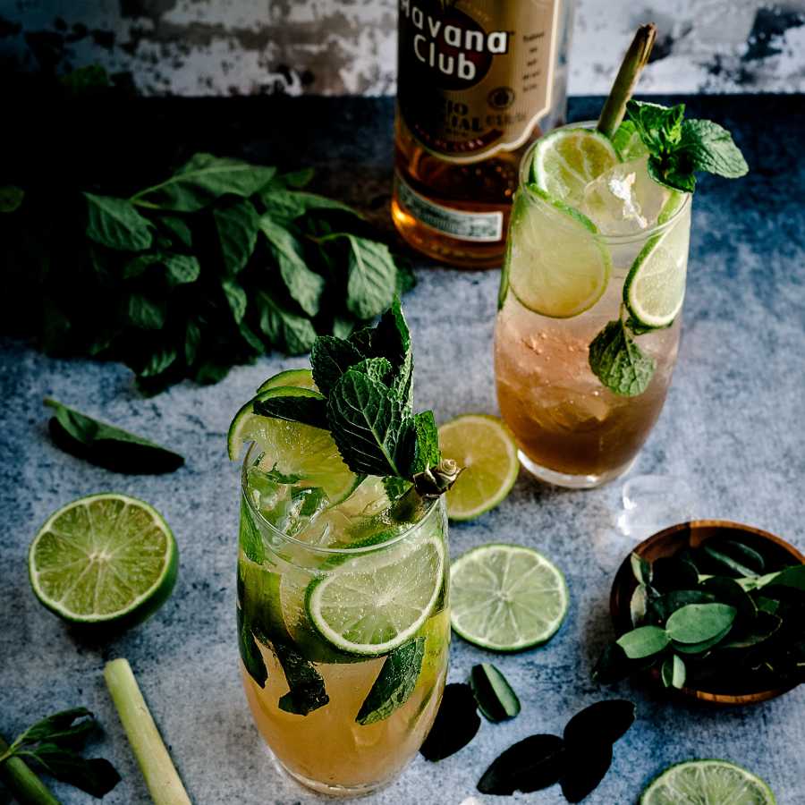 Two cocktails alongside a bottle of Havana Club