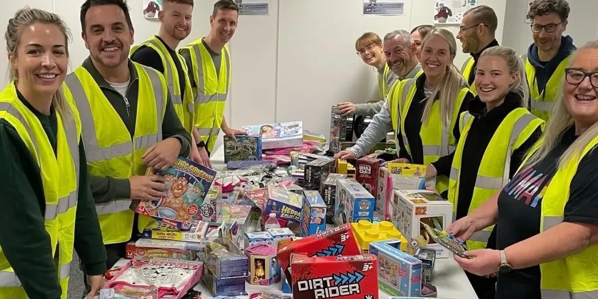 Employees assembling care packages for people in need during charity team building event