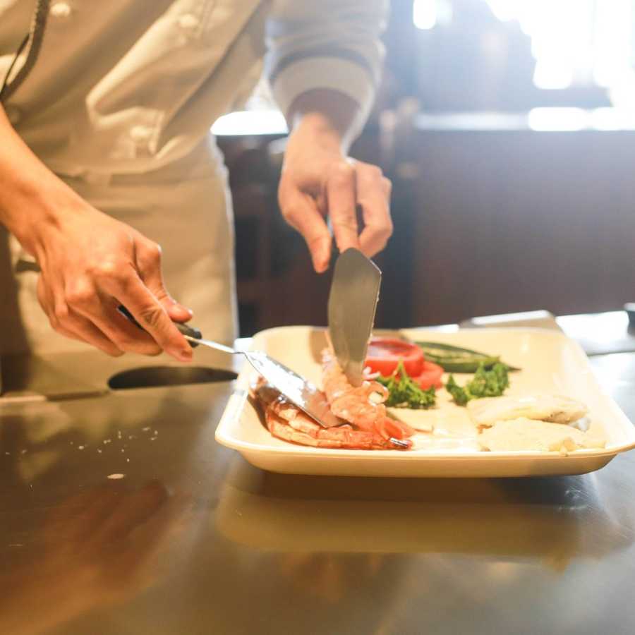 Chef placing food onto a plate