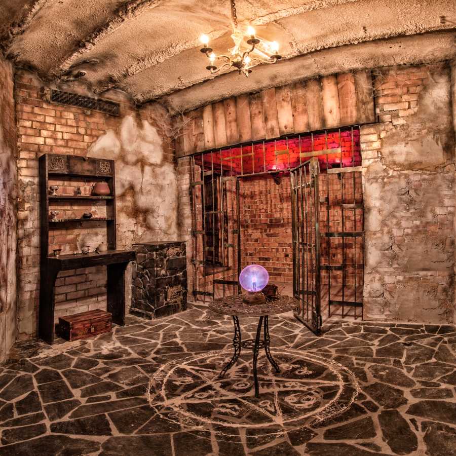 Digital recreation of a virtual escape room with prison doors and a purple glowing globe