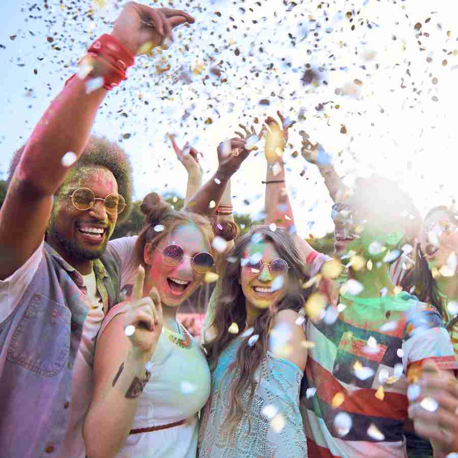 People cheering and throwing confetti at a company fun day