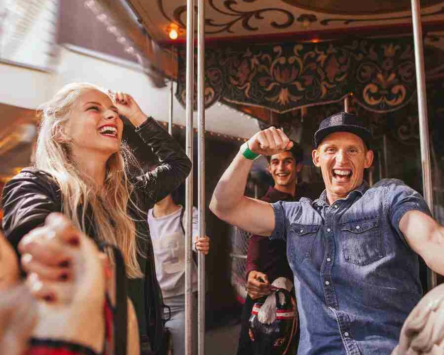 Adults smiling on a carousel on a company fun day