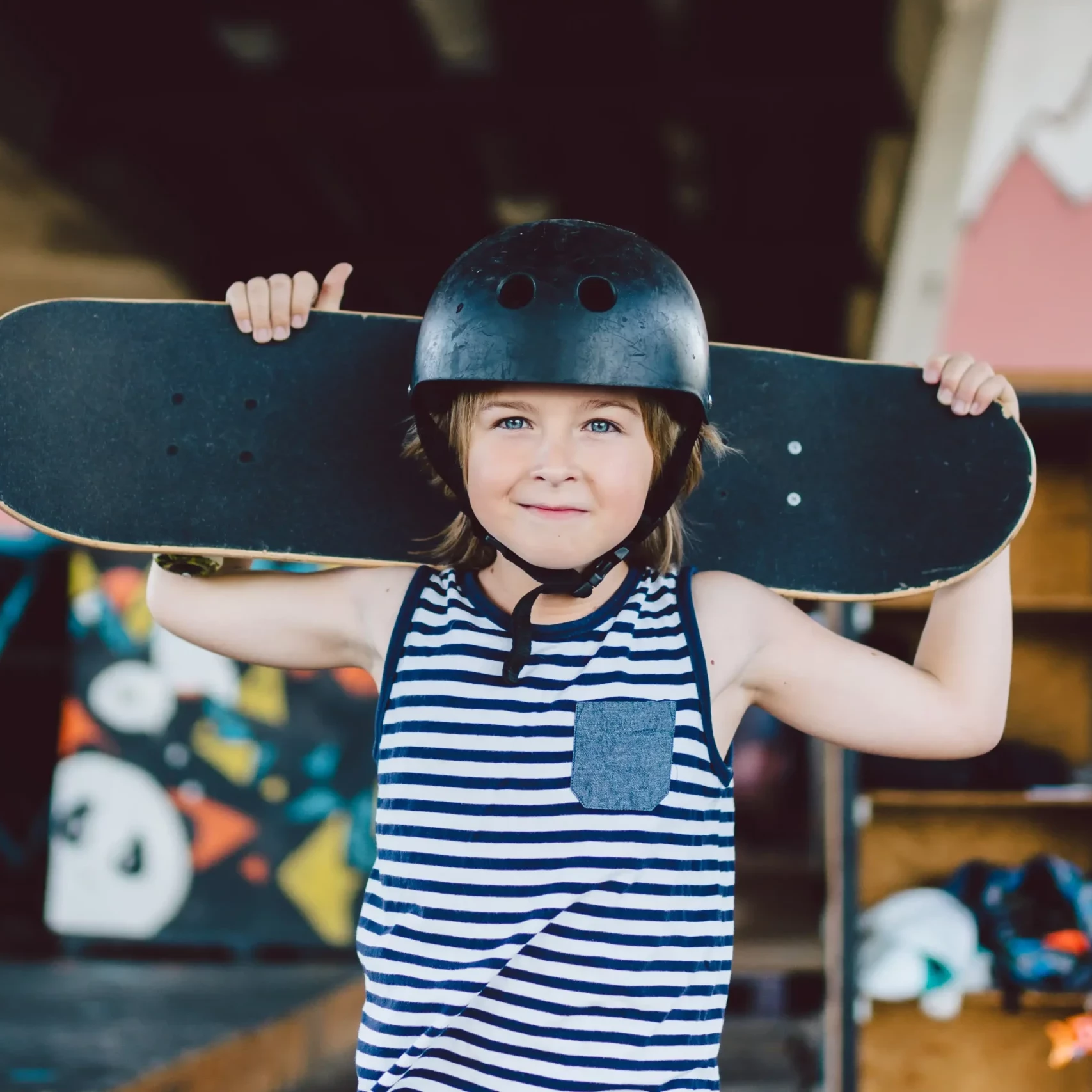 little girl with helmet holding skateboard from charity team building event