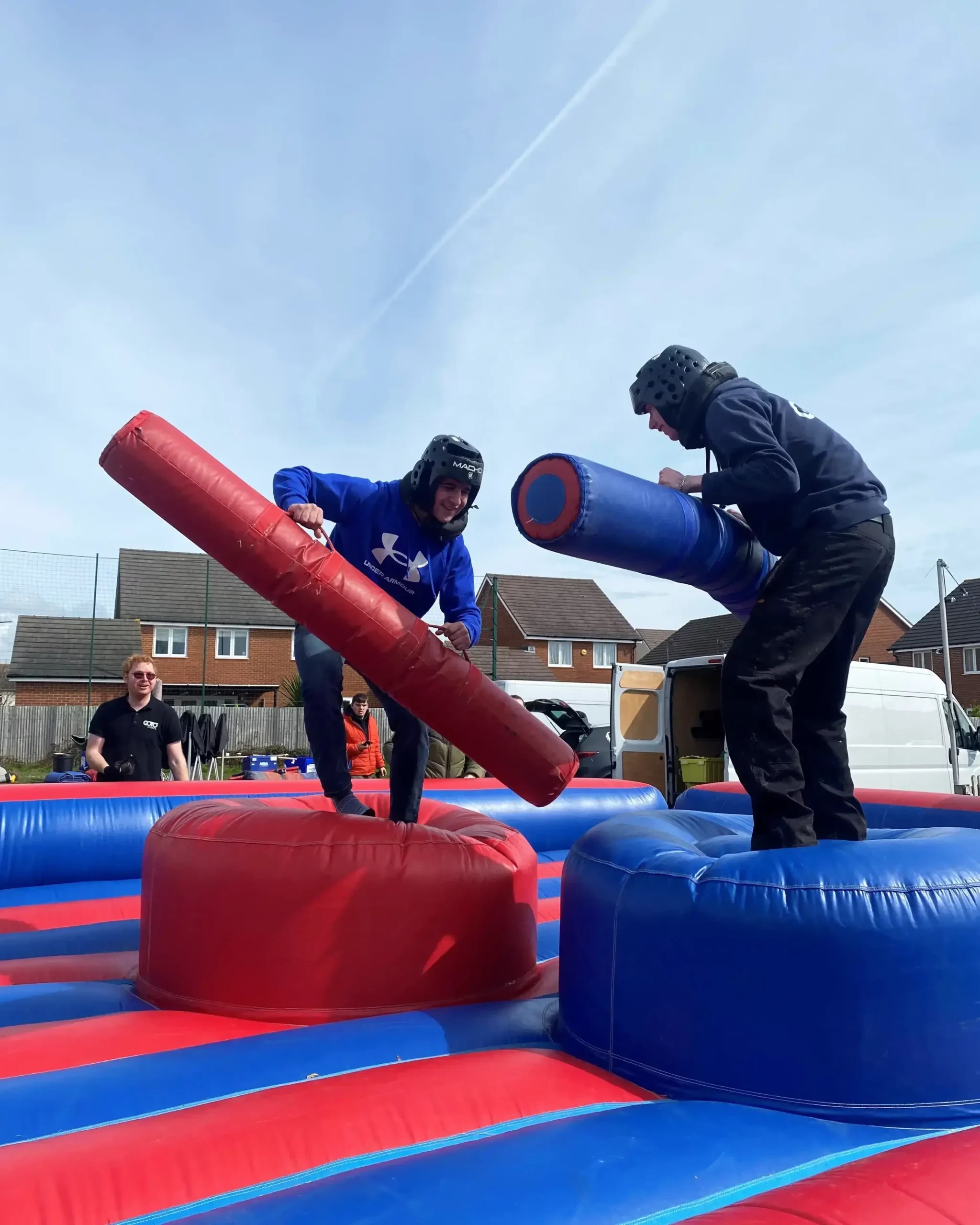 two people competing in gladiator challenge in company sports day